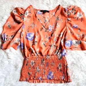 Medium orange blouse with blue and white flowers